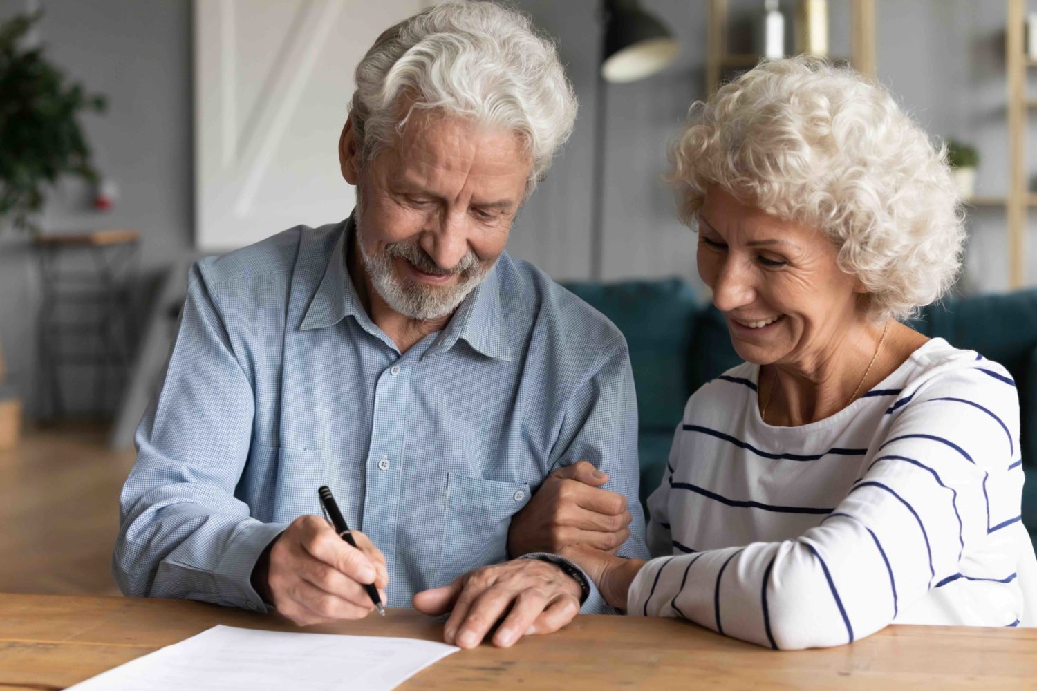 elderly-spouses-signing-document-at-law-firm